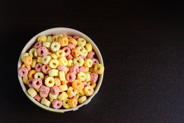 Cereal flakes in bowl on table top view with copy space