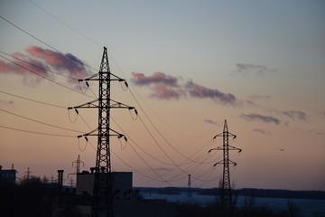 silhouette of electricity pylons at sunset