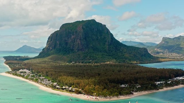 Aerial Drone of Le Morne Brabant Mountain.
Flying Away Shot Revealing Coastline with Kiters Surfing On Tropical Turquoise Blue Water.