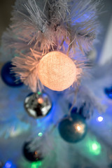 New Year's background - Christmas tree decorated with garlands, close-up