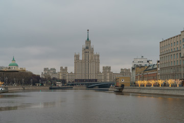 Fototapeta na wymiar Photography of Stalinist skyscraper on Kotelnicheskaya embankment and Observation Deck Zaryadye Park in winter overcast day. International touristic concepts.