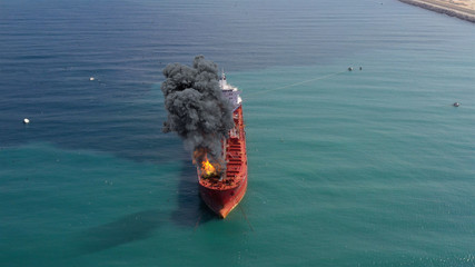 Aerial footage over Oil Tanker Ship Burning Under attack Aerial view with visual effect elements...
