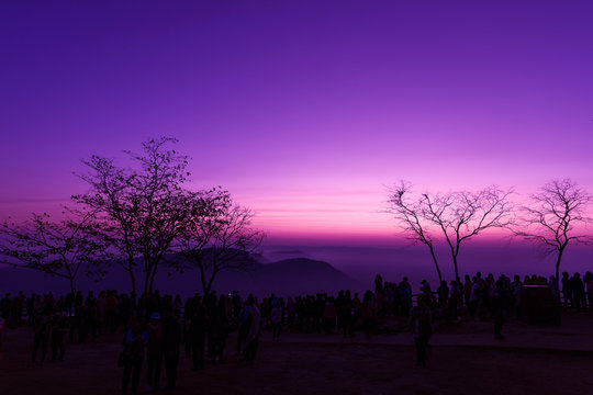 Starry sky scene on high mountains with people taking photograph of Scenic sunrise.
