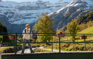 Fototapeta na wymiar smiling boy with backpack in Cirque de Gavarnie; Pyrenees mountains