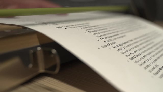 Someone in the tech office using the paper cutting machine. This is a close up shot of the action.
