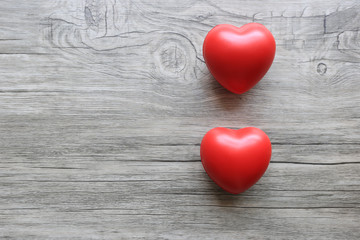 Donation Concept.Red heart on wooden background