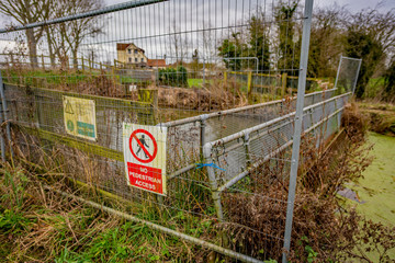 Flood defence structure on the bank of the River Yare in the Norfolk countryside