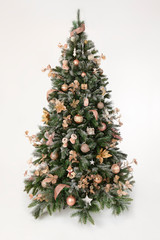 Magnificently decorated christmas tree in front of a white backround
