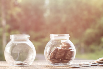 putting coins in jar with money stack step growing growth saving money, coins in glass jar for money saving financial, concept finance business investment.