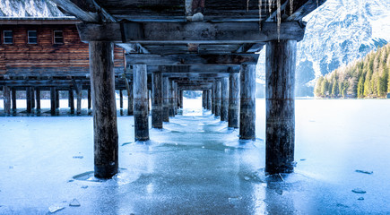 View from under the pier onto the frozen Lago di Braies