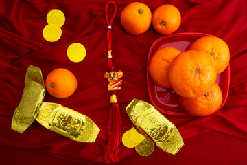 Oranges and gold on red fabric , Chinese New Year
