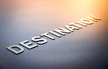 Word destination written with white solid letters
