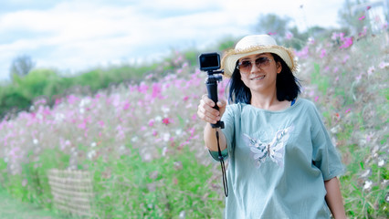 Beautiful blogger in the flowers garden