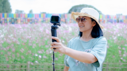 Beautiful blogger in the flowers garden