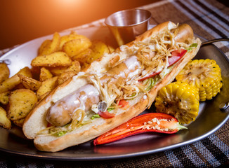 Hotdog and French fries on a dish. Fast food meal. Restaurant.
