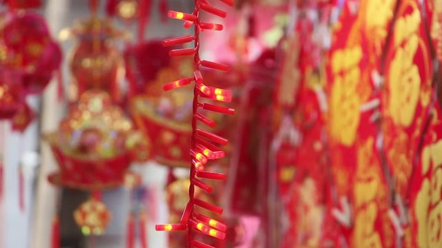 Flashing glowing Chinese New Year firecracker decoration lantern closeup. Text meaning on the picture: wish, auspicious