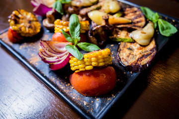 Tasty grilled vegetables on big plate. Healthy food. Restaurant.