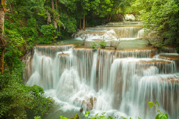 Fototapeta na wymiar Breathtaking waterfall at deep forest, Tropical rain forest or evergreen forest with waterfall, Erawan waterfall located Kanchanaburi Province, Thailand