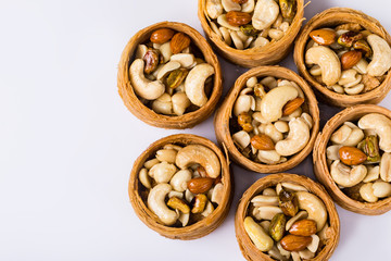 Oriental sweets, baklava, Turkish delight with almonds, cashews and pistachios on plates.