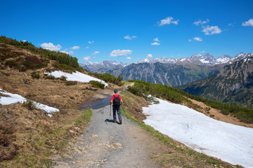 Wanderer auf dem Weg zur Mittelstation der Fellhornbahn, Allg&auml;uer Alpen im Fr&uuml;hjahr. Ausflugsziel bei Oberstdorf