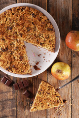 crumble with pear and chocolate on wood background