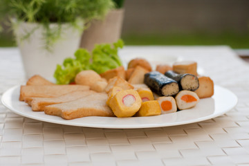 Appetizers, Meat ball , fish ball and sausage with sauce on white dish