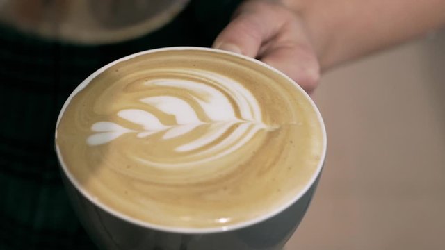 Barista making of cafe latte art, heart shape
