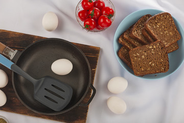 Home cooking. Eggs, cherry tomatoes herbs pan