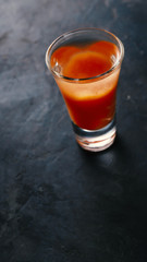 Bloody mary cocktail on a concrete dark table