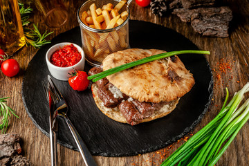 Turkish, oriental cuisine. Turkish tortilla, bun, pita bread with kebab and pickled onions. Serving...