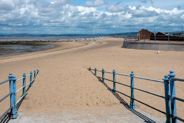 Sandy path to Morecombe beach with blue handrails