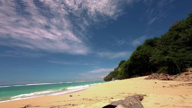 Beautiful tropical white sandy beach of Pantai Gunung Payung in Bali. wide view from action camera.