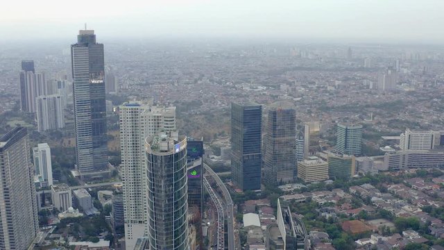 Top Down Aerial Aerial drone  view of Jakarta city skyscrapers during the afternoon under cloudy day. Reveal Wide shot on 4K DJI Mavic 2