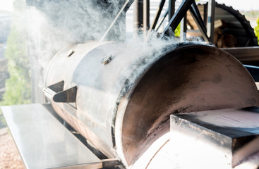 Large barbecue smoker grill at the park. Meat prepared in barbecue smoker.