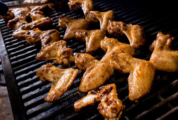 Fried chiken wings at grill barbecue. Restaurant.