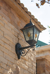street lamp on a brick wall. corner of the wall of light decorative brick