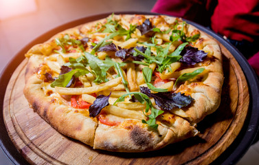 Tasty pizza with chicken and vegetables. Restaurant.