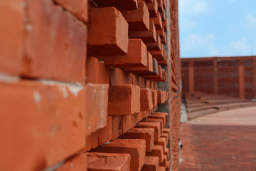 Obraz na płótnie Canvas Red bricks wall material close up and blue sky