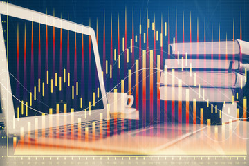 Forex market graph hologram and personal computer on background. Multi exposure. Concept of investment.