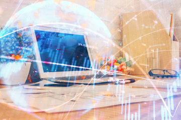 Stock market graph on background with desk and personal computer. Multi exposure. Concept of financial analysis.