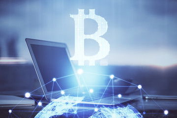 Double exposure of blockchain theme hologram and table with computer background. Concept of bitcoin crypto currency.