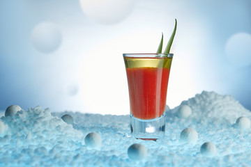 Bloody Mary cocktail, decorated with greenery, in a surreal lunar landscape close-up. Horizontal image.