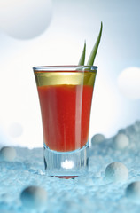 Bloody Mary cocktail, decorated with greenery, in a surreal lunar landscape close-up. Vertical image.