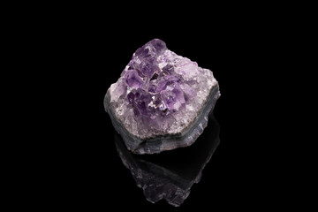 Purple rough Amethyst quartz crystals geode isolated on black