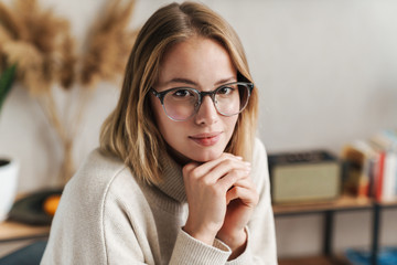 Photo of nice attractive woman in eyeglasses looking at camera