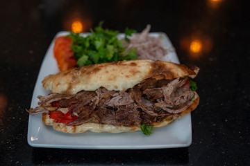 close up of kebab sandwich on wooden background