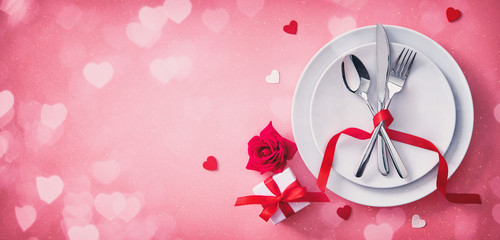 Red table setting cutlery for valentines days dinner