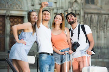 Joyful a group of friends doing selfies on the phon