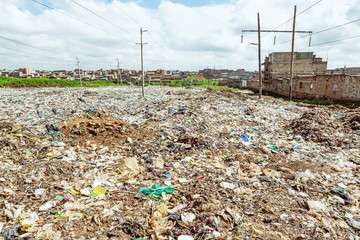 Mountain of rubbish and plastic bags, in the Dandora landfill in Nairobi, with marabu birds. High...