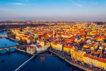 Aerial Prague panoramic drone view of the city of Prague at the Old Town Square, Czechia. Prague Old Town pier architecture and Charles Bridge over Vltava river in Prague at sunset, Czech Republic.